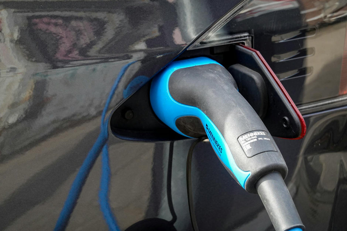 EV charging connector plugged into an electric car