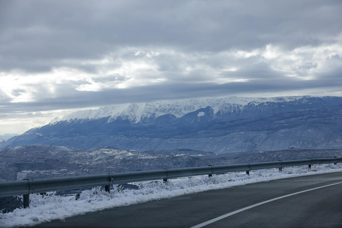 Snow-covered alpine mountain road in winter